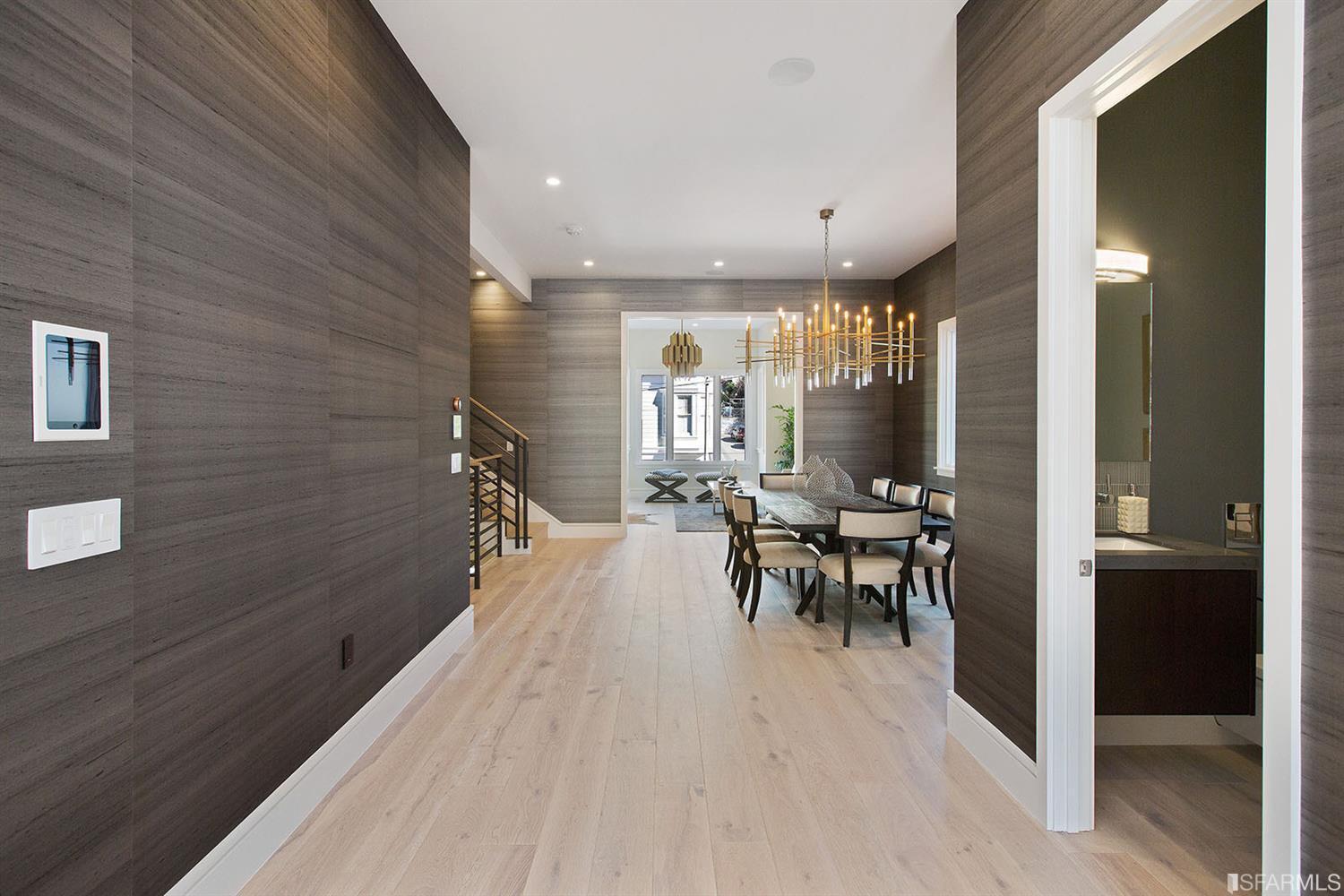 Hallway with dark paneled walls SF residence