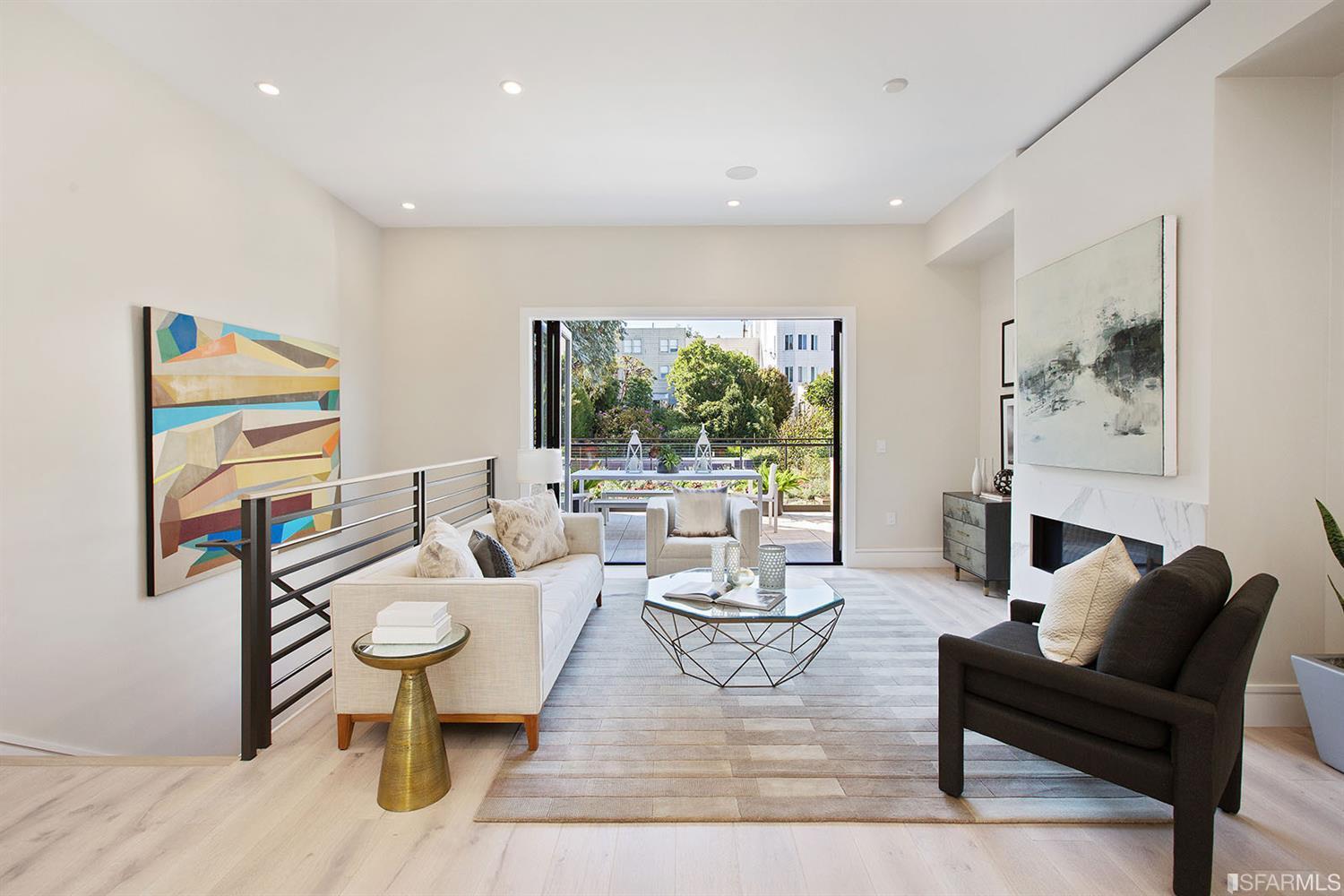 Common area with sofa chair glass coffee table SF residence image #1
