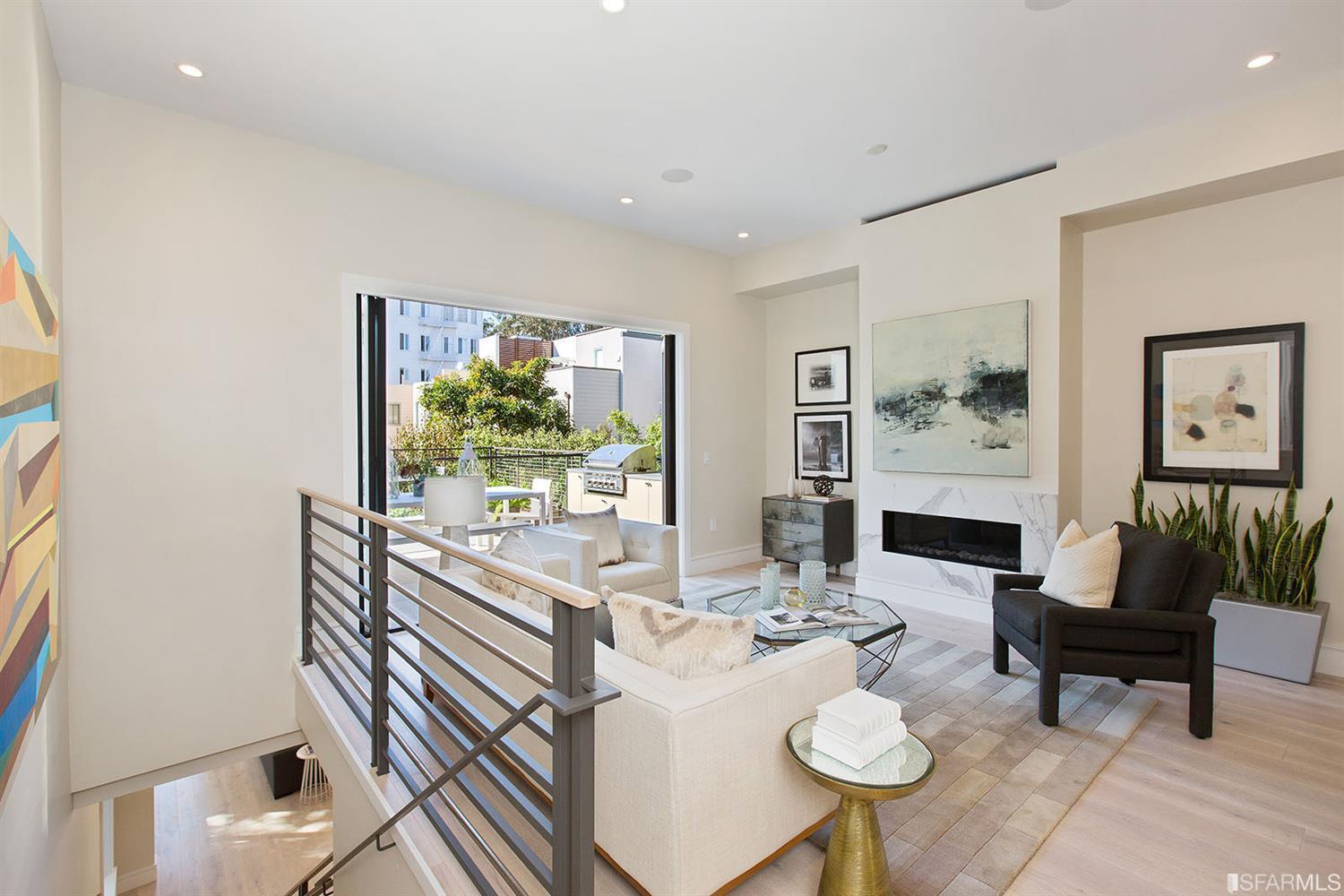 Common area with sofa chair glass coffee table SF residence image #2