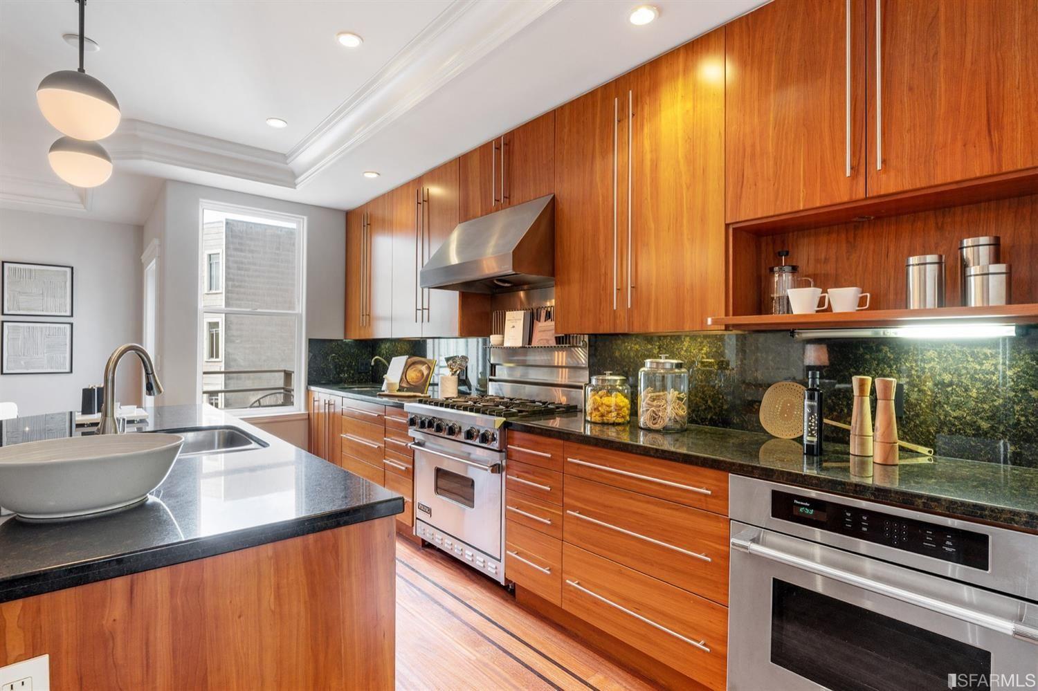 217-219 16th Avenue Kitchen with butcher block and stoves, rich hardwood cabinets. 