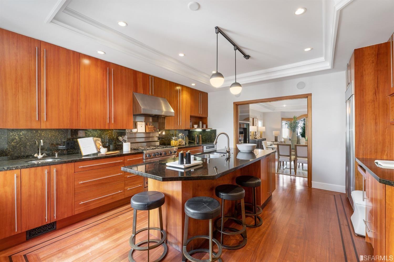 217-219 16th Avenue Long view of kitchen accenting the beautiful wood. Stools set up around butcher block. 