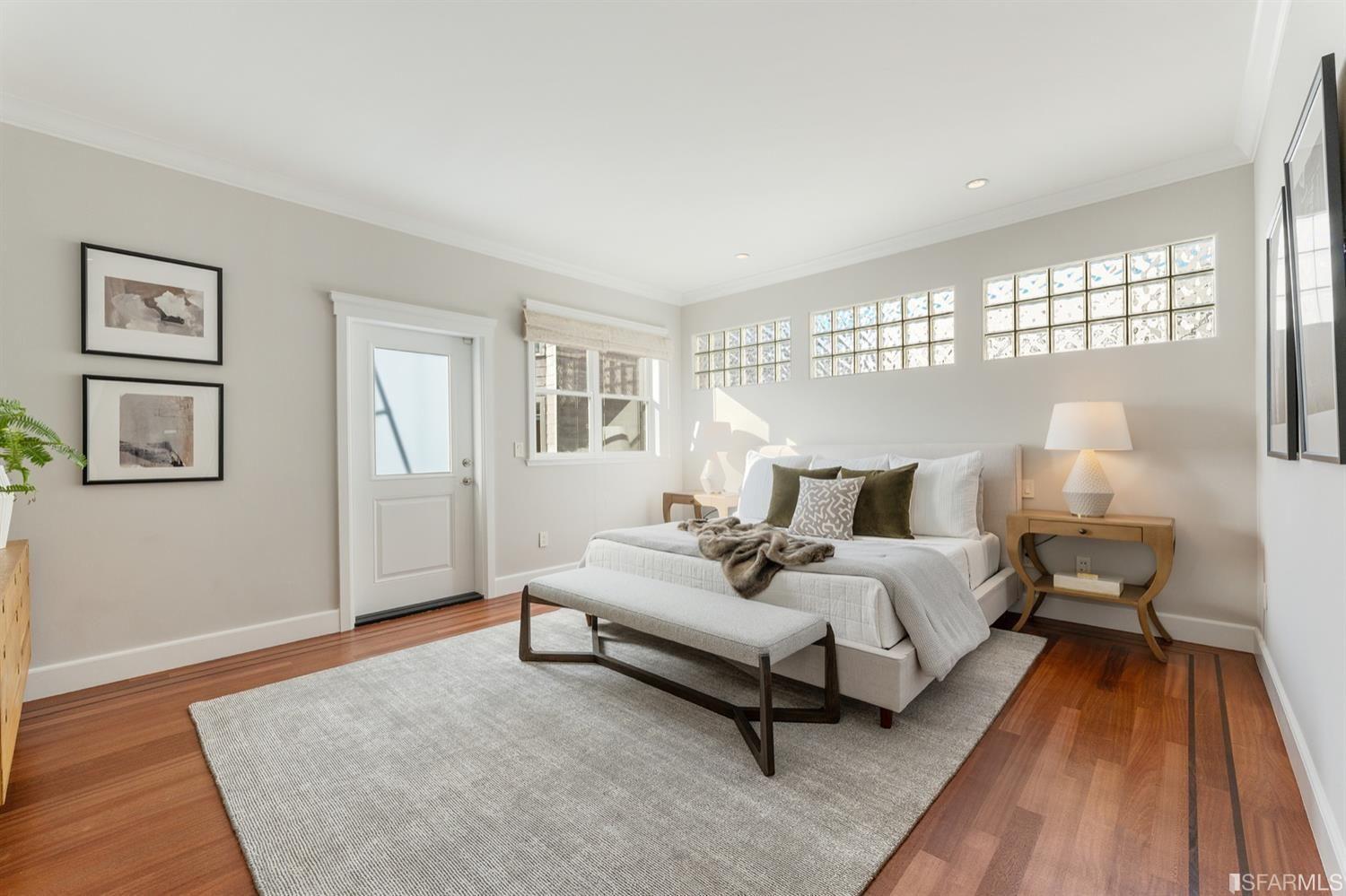 217-219 16th Avenue Master bedroom with glass brick, and wood floors. 