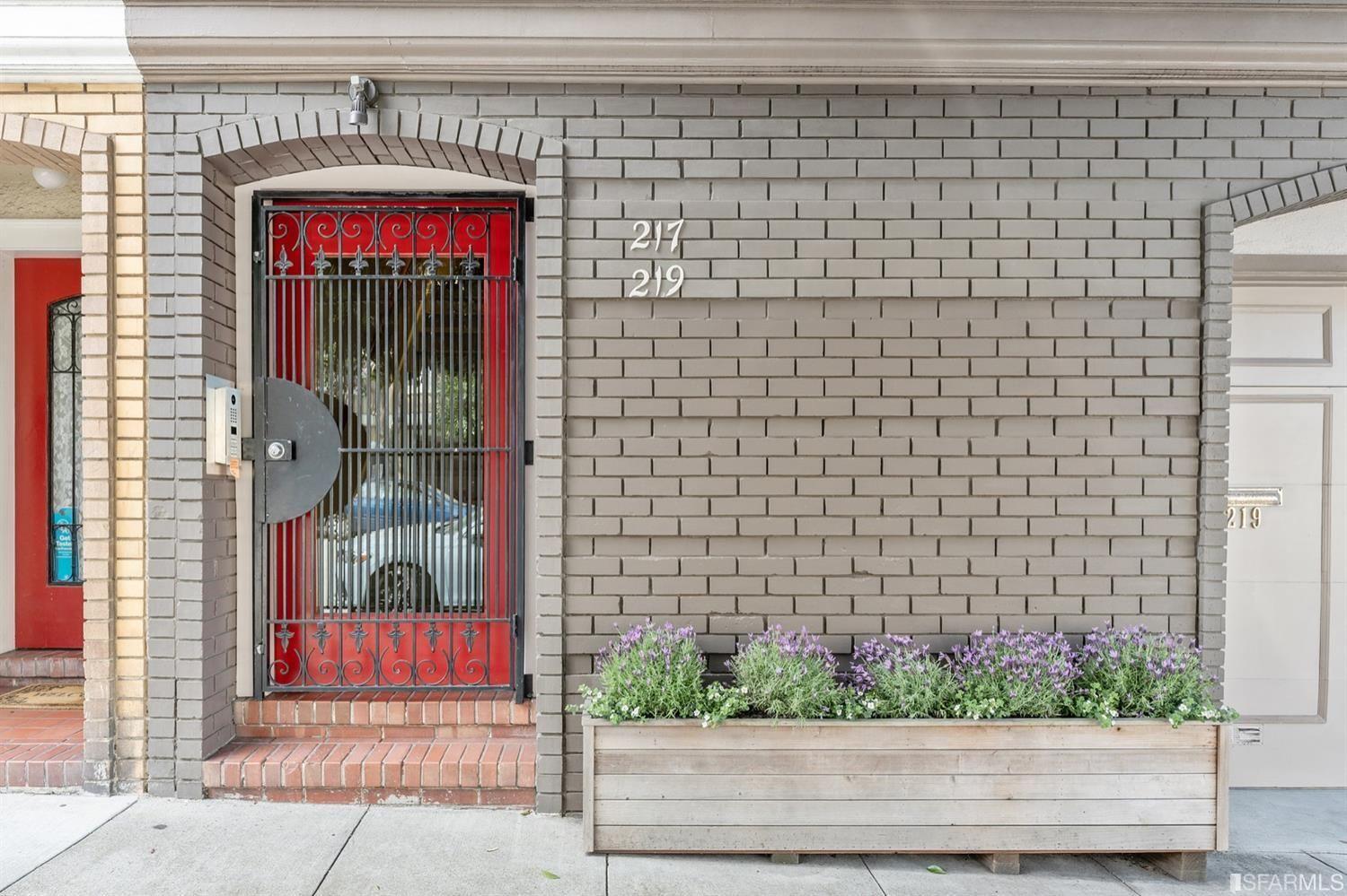 217-219 16th Avenue Entrance with red door and iron gate. 