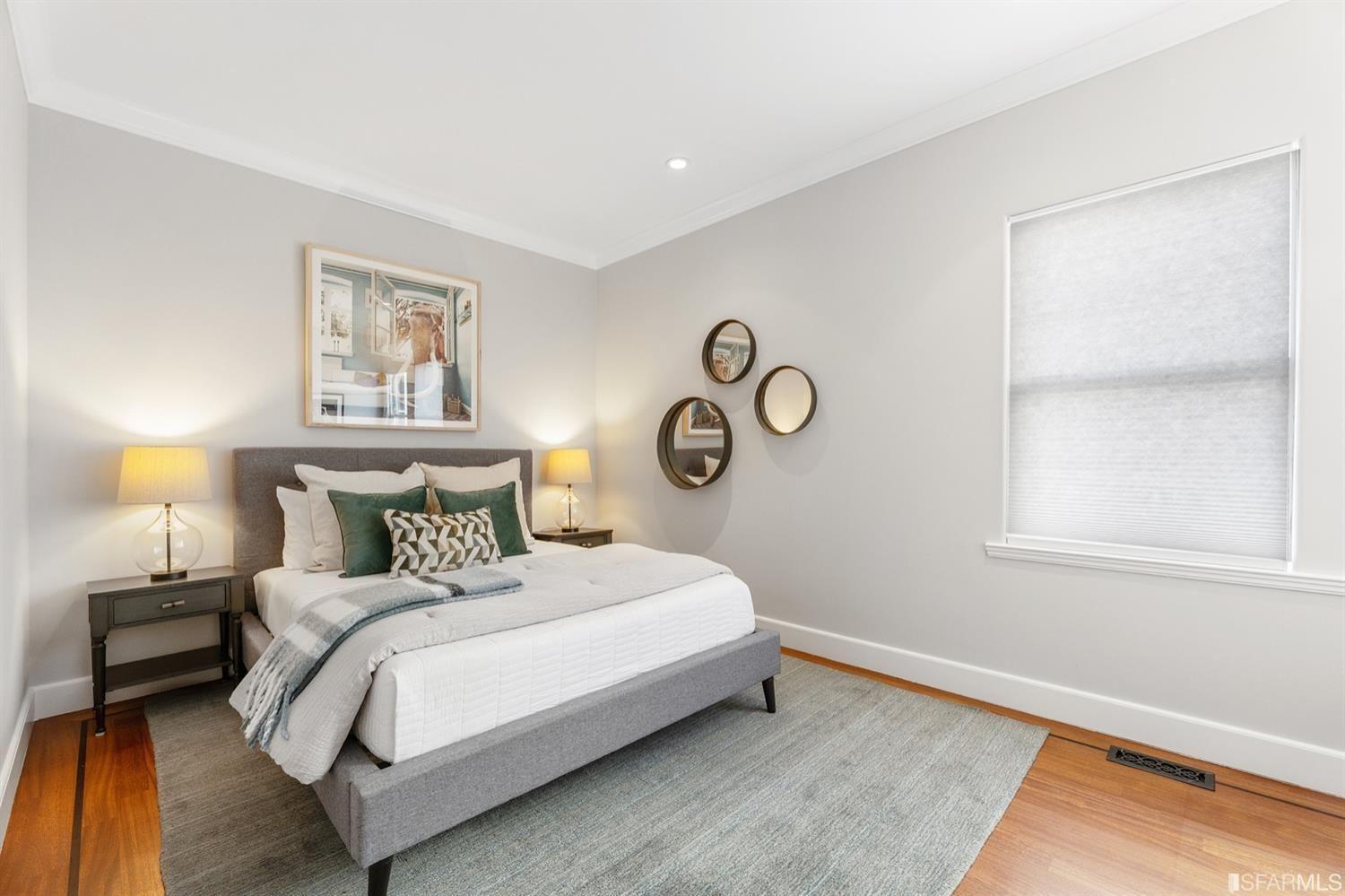 217-219 16th Avenue Second bedroom mirrors on the wall, and framed photo.