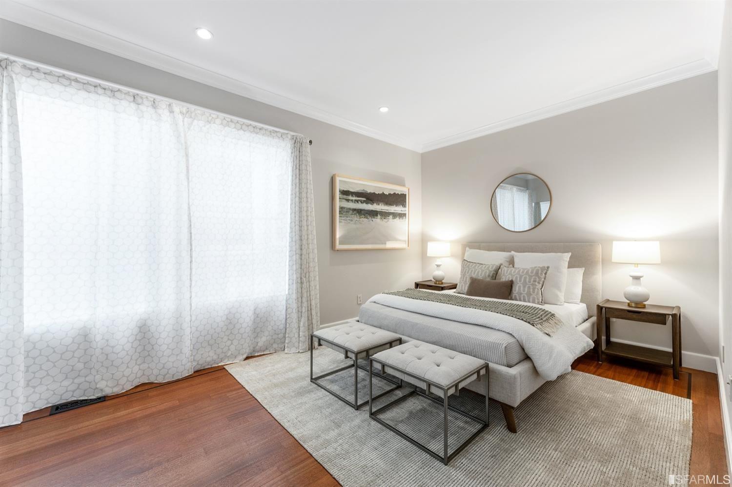 217-219 16th Avenue Bedroom with circular mirror over the bed. 