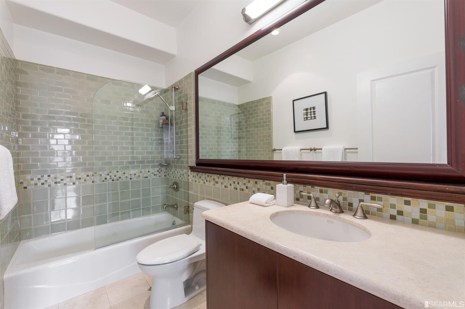 217-219 16th Avenue Second bath with tiled Tub/Shower sink and mirror.