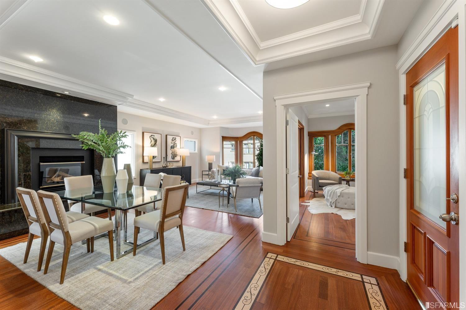 217-219 16th Avenue Longview of dining room with glass table, fireplace and front door. 