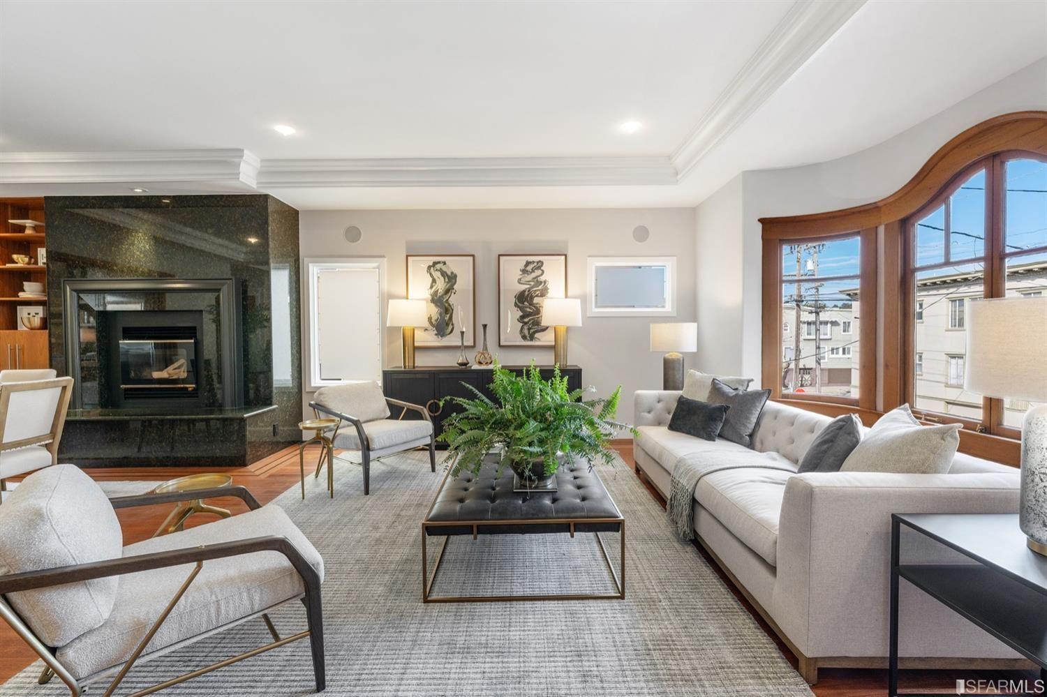 217-219 16th Avenue Large living room with wood stove, modern art, and a plant. 